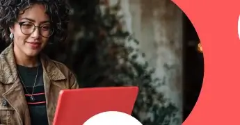 Person using a red laptop in an outdoor setting